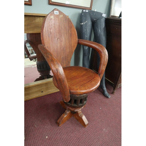 342 - Unusual carved swivel armchair on antique cartwheel hub base