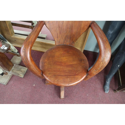 342 - Unusual carved swivel armchair on antique cartwheel hub base