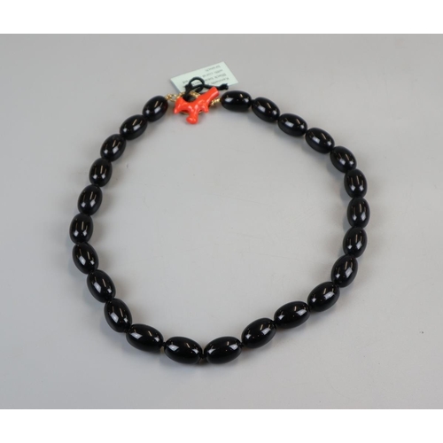 50 - Kenneth J Lane black bead necklace with coral coloured clasp