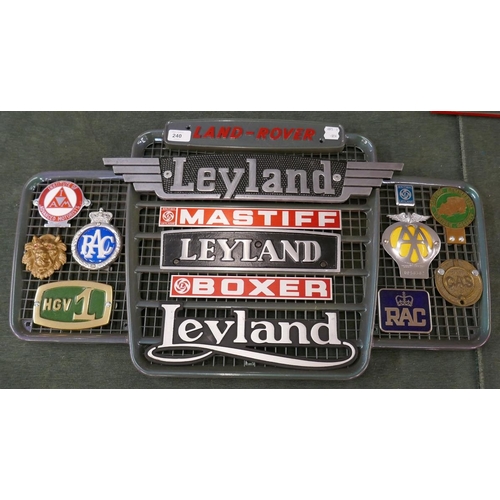 240 - Collection of badges to include mainly Leyland, RAC and AA mounted on a Land Rover grill