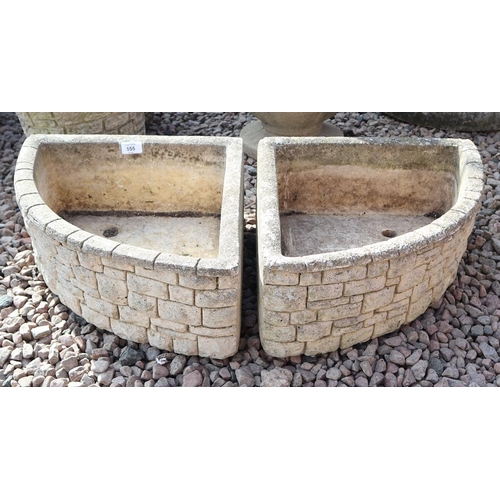 555 - Pair of stone corner planters 