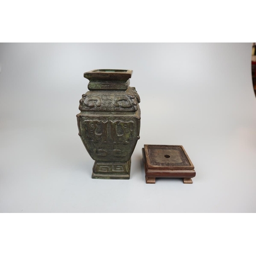 102 - Heavy Aztec bronze vase on wooden stand - Approx height: 26cm