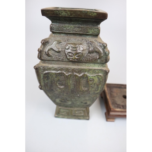 102 - Heavy Aztec bronze vase on wooden stand - Approx height: 26cm