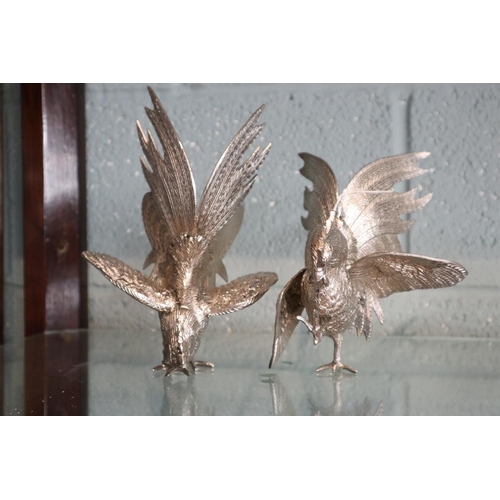 104 - Pair of white metal fighting cockerels