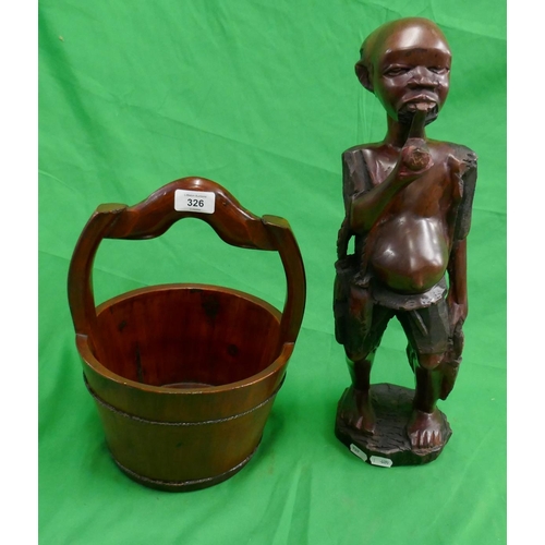 326 - African wooden carving along with well bucket - Approx height of carving: 48cm