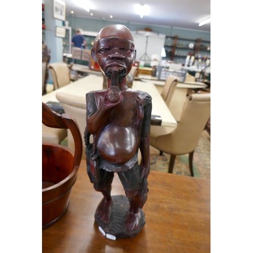 326 - African wooden carving along with well bucket - Approx height of carving: 48cm