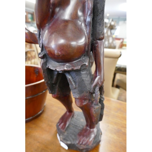 326 - African wooden carving along with well bucket - Approx height of carving: 48cm