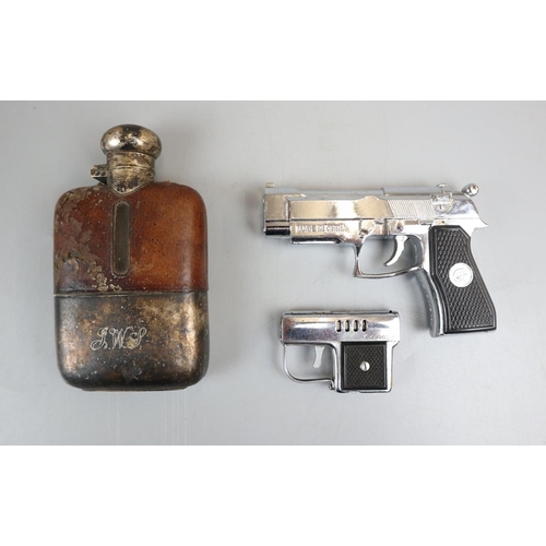 78 - 2 Pistol lighters and a hip flask