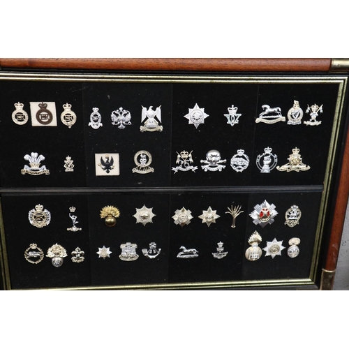 104 - 2 collections of framed military badges