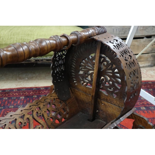 140 - An unusual 19th century style wooden Ottoman Empire rocking cradle with central bar holding baby rin... 