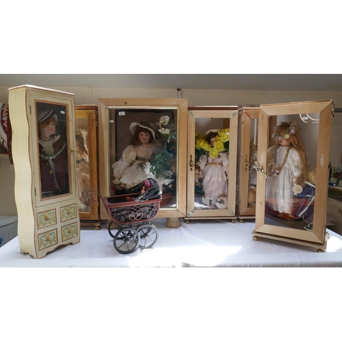 417 - Collection of dolls in display cases etc