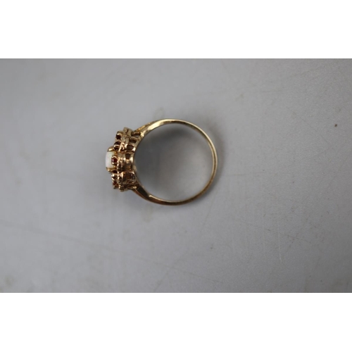 64 - Gold garnet and opal set ring - Approx. size: P