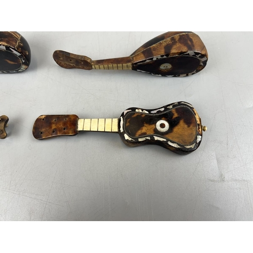 94 - 4 miniature tortoise-shell & mother of pearl musical instruments