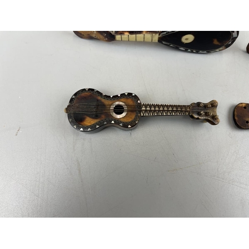 94 - 4 miniature tortoise-shell & mother of pearl musical instruments