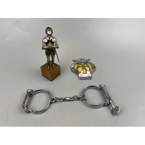 95 - AA badge together with vintage handcuffs and metal figure of a knight