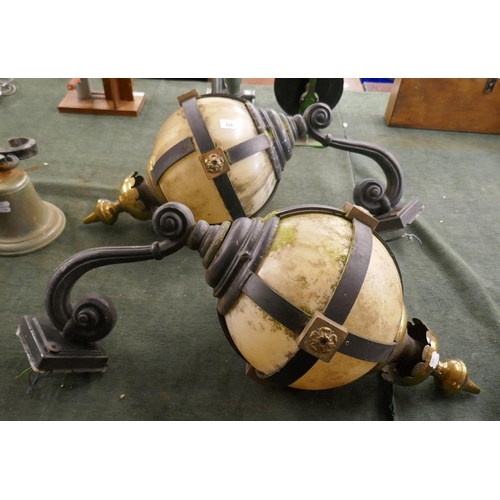 104 - Pair of ornate wrought iron orb wall lights