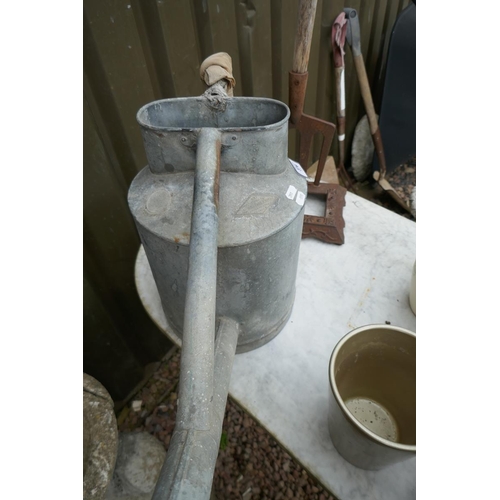 376 - Good quality galvanised watering can together with a boot scrape