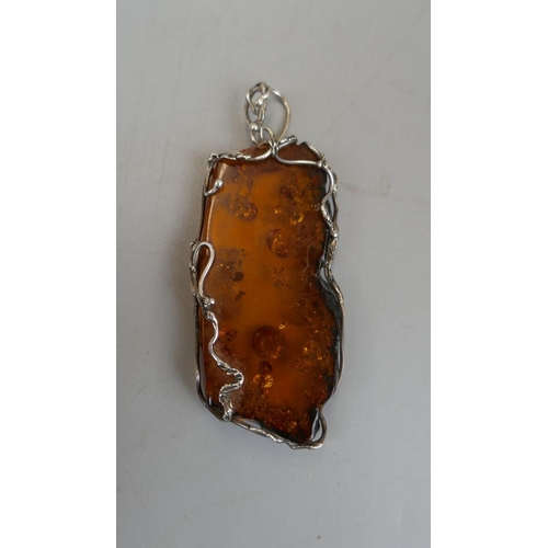 39 - Large amber pendant with silver mount