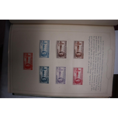 59 - 2 well populated stamp albums together with a reference book