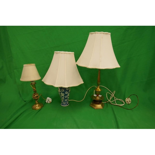 149 - 2 brass lamps together with a blue and white lamp