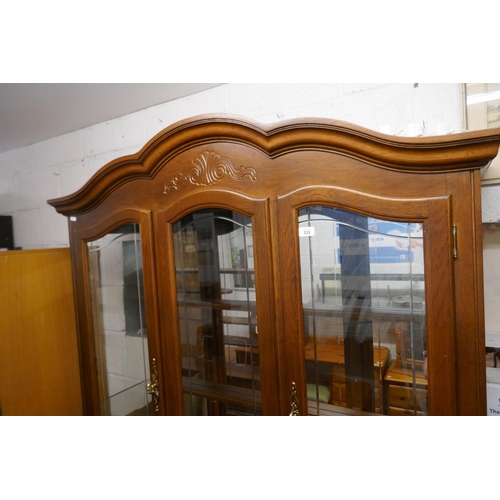 232 - Large glazed display cabinet on base - Approx size: W: 132cm D: 44cm H: 214cm