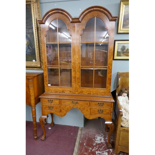 255 - Queen Anne style walnut 2 domed bookcase with a glazed top sitting on cabriole legs on ball and claw... 