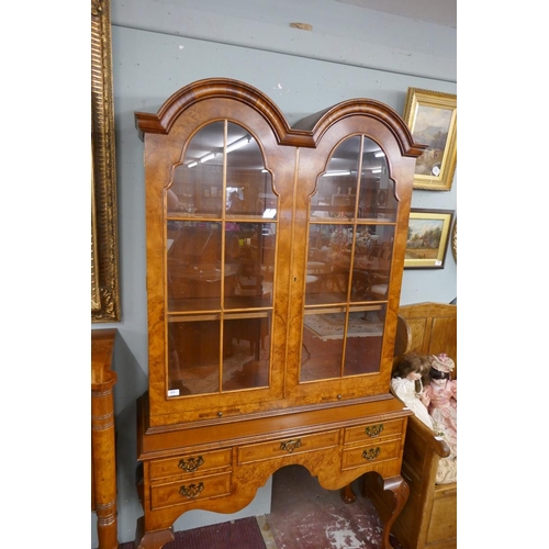 255 - Queen Anne style walnut 2 domed bookcase with a glazed top sitting on cabriole legs on ball and claw... 