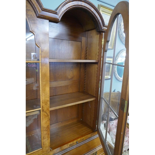 255 - Queen Anne style walnut 2 domed bookcase with a glazed top sitting on cabriole legs on ball and claw... 