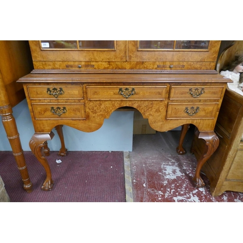 255 - Queen Anne style walnut 2 domed bookcase with a glazed top sitting on cabriole legs on ball and claw... 