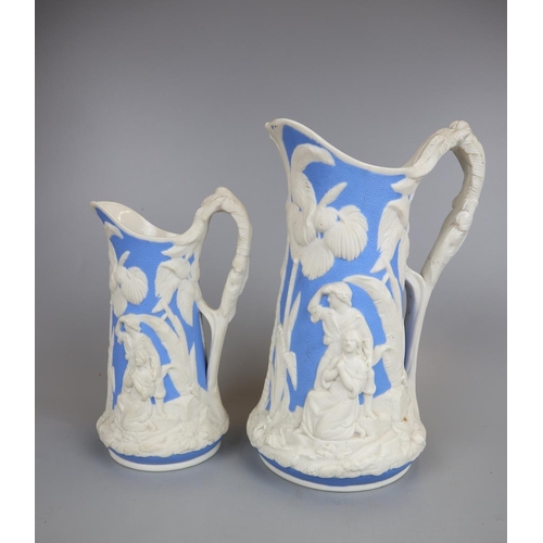 104 - 2 graduated T J & J Mayer Antique Victorian Moulded Parian Ware Jugs 'The Family' c1850