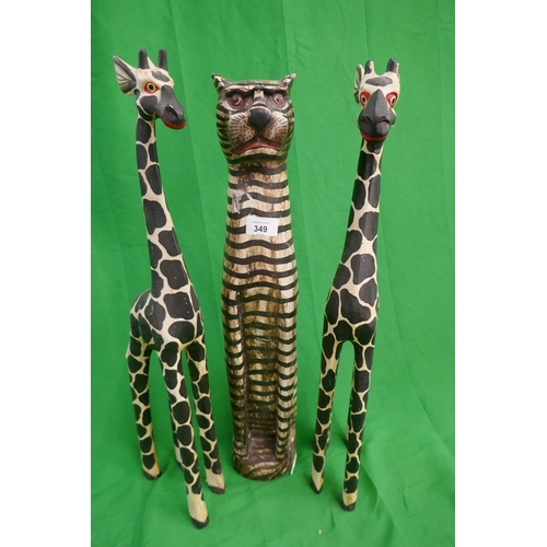 349 - Pair of carved giraffes together with carved cat - Approx height of tallest: 60cm