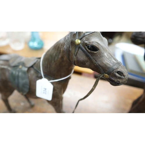 334 - 2 Liberty style leather model horses - Approx height of tallest: 35cm