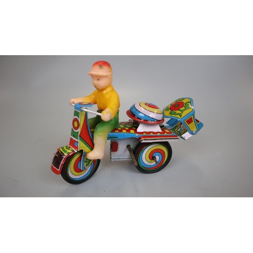 160 - Jaguari man on motorcycle tin plate toy