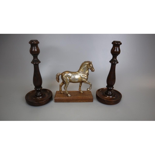 172 - Metal figurine of horse on wooden base together with a pair of turned wooden candlesticks