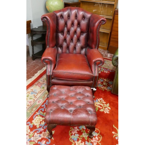 379 - Ox-blood leather wing back chair together with matching stool