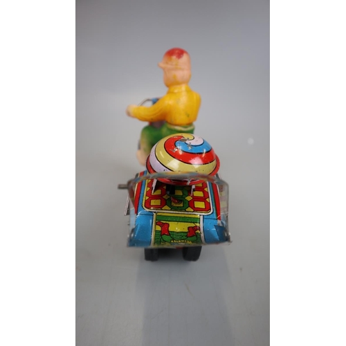 160 - Jaguari man on motorcycle tin plate toy