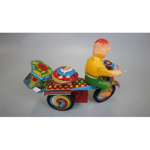 160 - Jaguari man on motorcycle tin plate toy