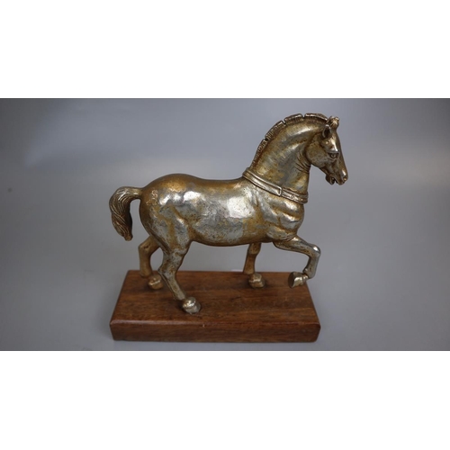 172 - Metal figurine of horse on wooden base together with a pair of turned wooden candlesticks