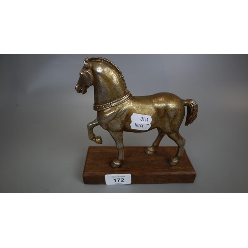 172 - Metal figurine of horse on wooden base together with a pair of turned wooden candlesticks