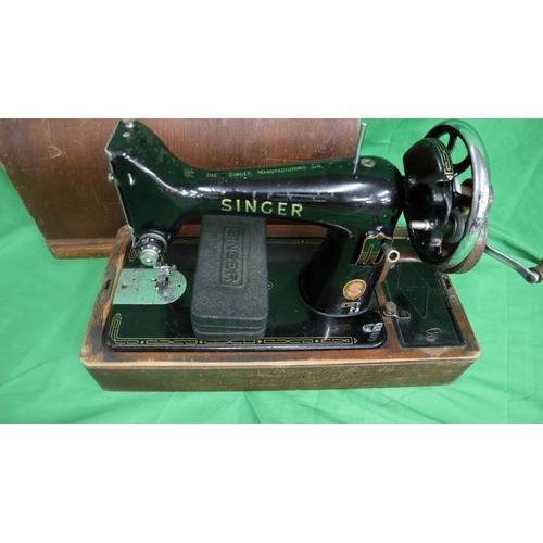 194 - Singer sewing machine together with a sewing table