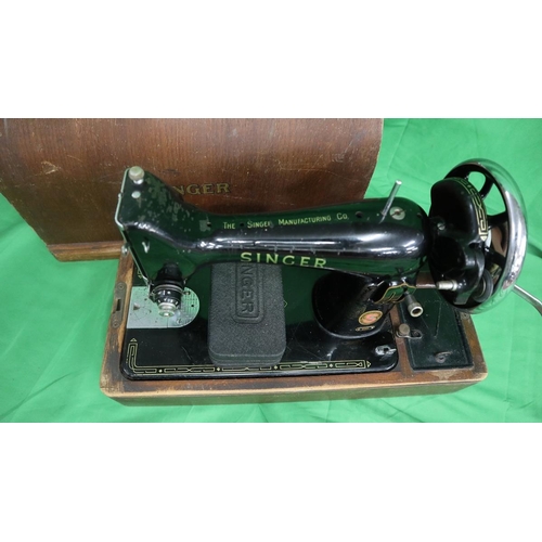 194 - Singer sewing machine together with a sewing table