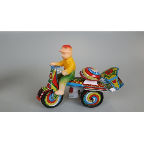 140 - Jaguari man on motorcycle tin plate toy