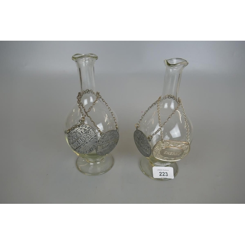 223 - Pair of hand blown bottles to include 3 pewter and 1 silver plated bottle collars