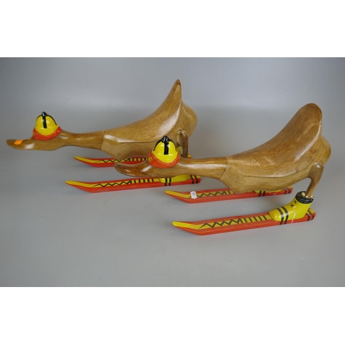 262 - Two novelty wooden ducks on skis