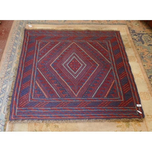 389 - A red and blue patterned wool rug - Approx size: 121cm x 115cm