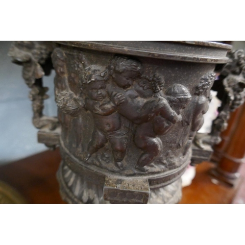 214 - Collectables to include a metal cherub vase