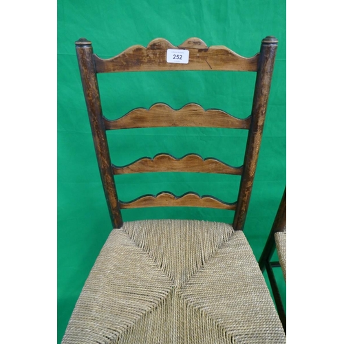 252 - Pair of ladder-back rush seated chairs