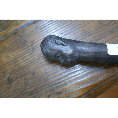 201 - Ebonised carved walking cane