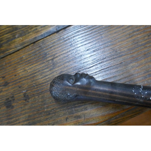 201 - Ebonised carved walking cane