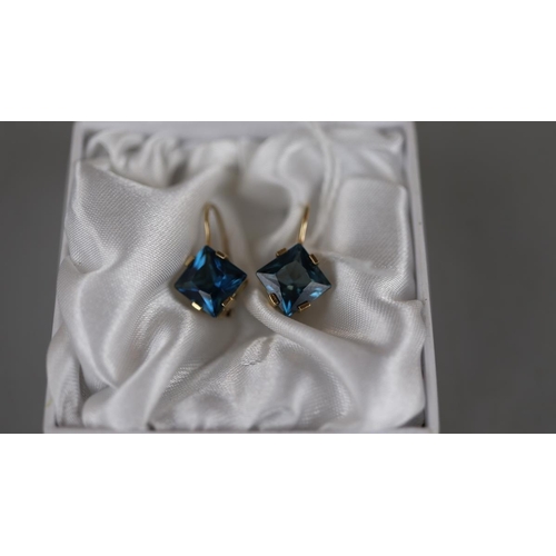 28 - Pair of gold blue topaz earrings